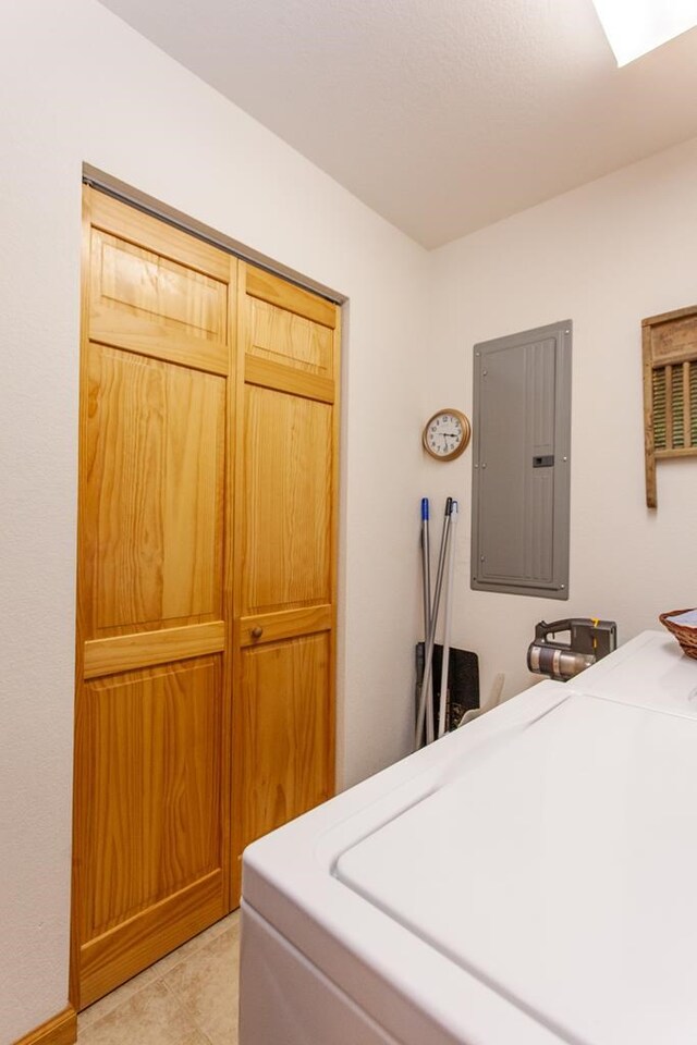 laundry room with electric panel and cabinets