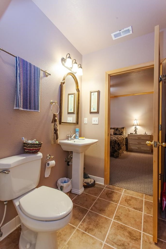 bathroom featuring tile patterned floors, toilet, and sink