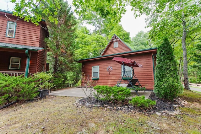 view of side of home with a patio