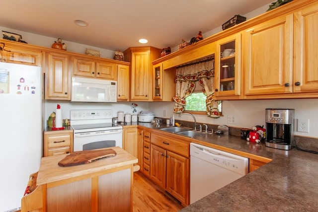 kitchen with wood counters, light wood-type flooring, white appliances, and sink