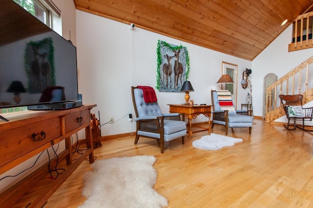 sitting room featuring light wood-type flooring, high vaulted ceiling, and wooden ceiling