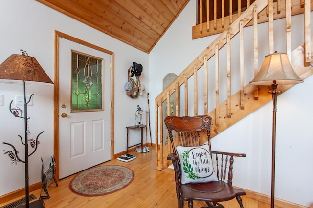 foyer featuring hardwood / wood-style floors, vaulted ceiling, ornamental molding, and wood ceiling