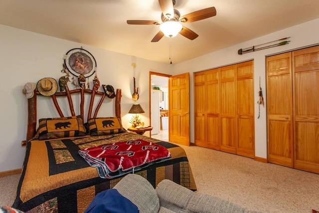 carpeted bedroom featuring two closets and ceiling fan