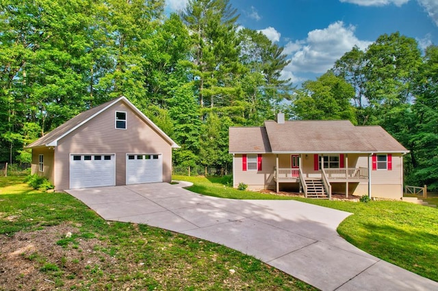 view of front of house with an outdoor structure, covered porch, a front yard, and a garage