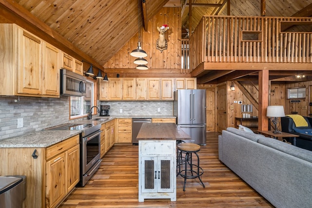 kitchen featuring hardwood / wood-style floors, pendant lighting, stainless steel appliances, and light brown cabinets