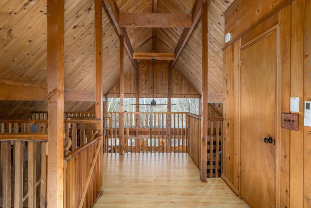 interior space with beamed ceiling, light hardwood / wood-style floors, high vaulted ceiling, and wooden ceiling