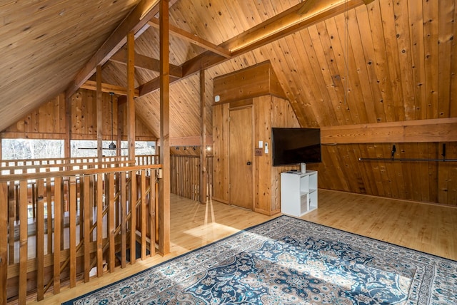 bonus room featuring vaulted ceiling with beams, light hardwood / wood-style floors, wooden ceiling, and wooden walls