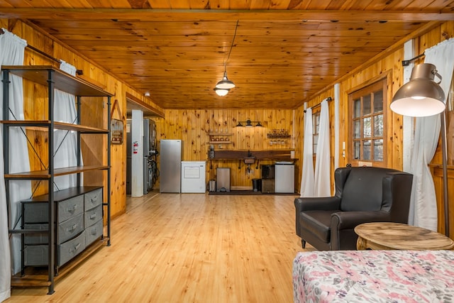 unfurnished living room with light hardwood / wood-style floors, wooden ceiling, and wooden walls