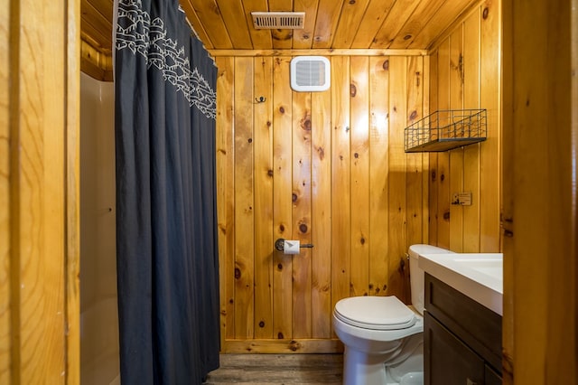 bathroom with vanity, wood walls, hardwood / wood-style flooring, toilet, and wood ceiling