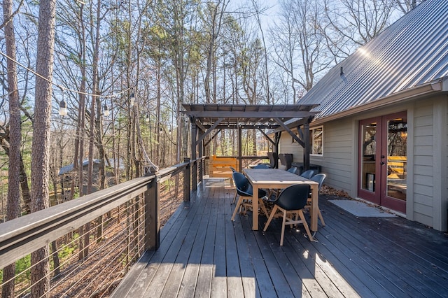 wooden deck featuring a pergola and french doors