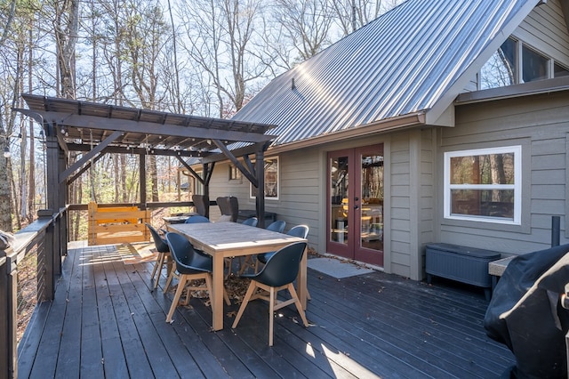 wooden deck with a pergola and french doors