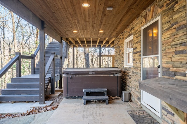 wooden terrace featuring a hot tub