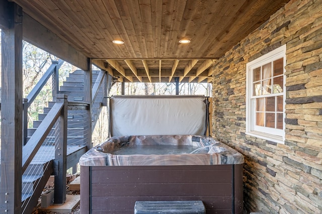 wooden deck featuring a hot tub