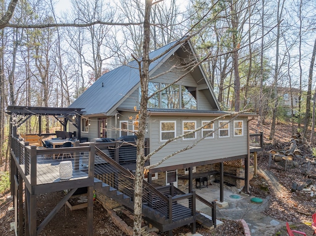 back of property with a pergola, a patio, and a deck