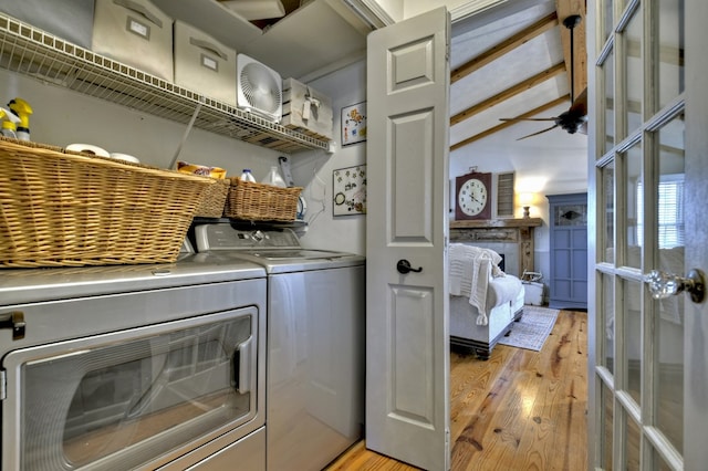 laundry area featuring light wood finished floors, laundry area, washer and dryer, and french doors