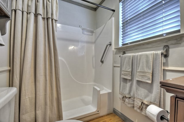 bathroom featuring toilet and a shower with curtain