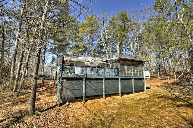 rear view of house with a deck and a sunroom