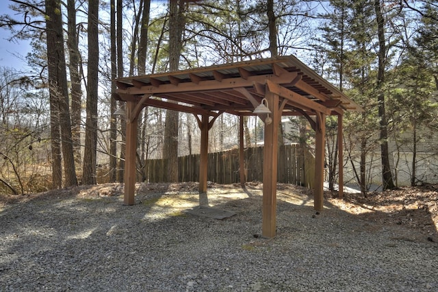 view of yard with fence and a detached carport