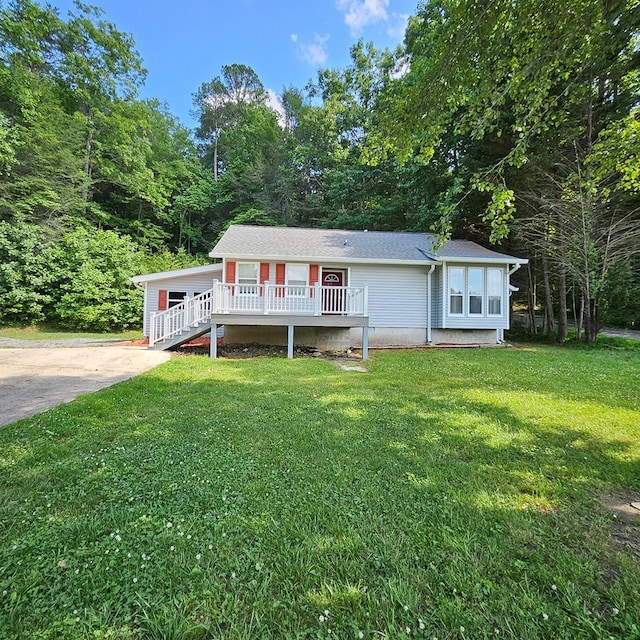 view of front of property with a front lawn and a wooden deck