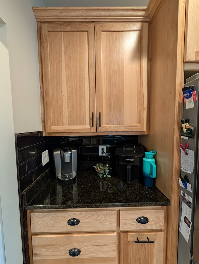 181 Charles Ln, Morganton, GA 30560 - kitchen featuring freestanding refrigerator, light brown cabinetry, tasteful backsplash, and dark stone counters