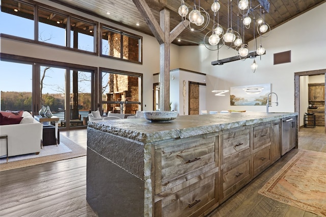 kitchen featuring a center island, wooden ceiling, high vaulted ceiling, hanging light fixtures, and wood-type flooring