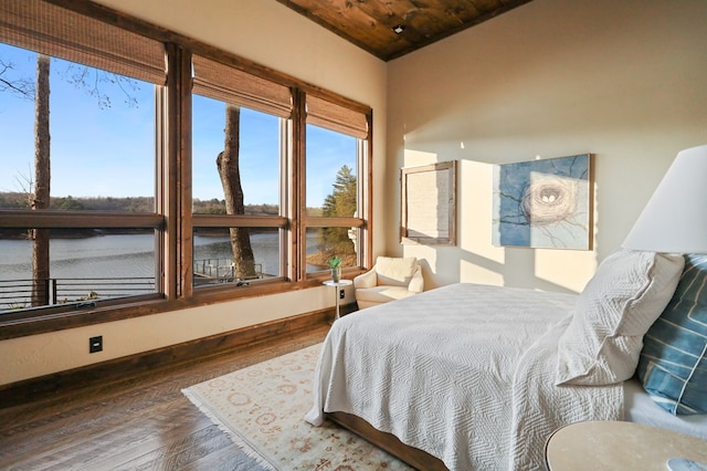 bedroom with wooden ceiling and dark wood-type flooring