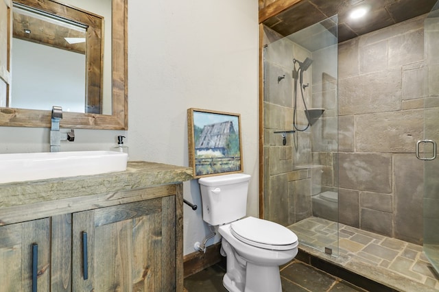 bathroom featuring vanity, toilet, and an enclosed shower