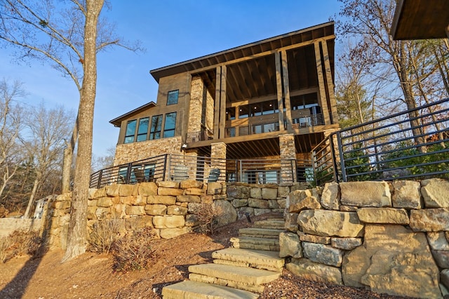 rear view of property with a balcony