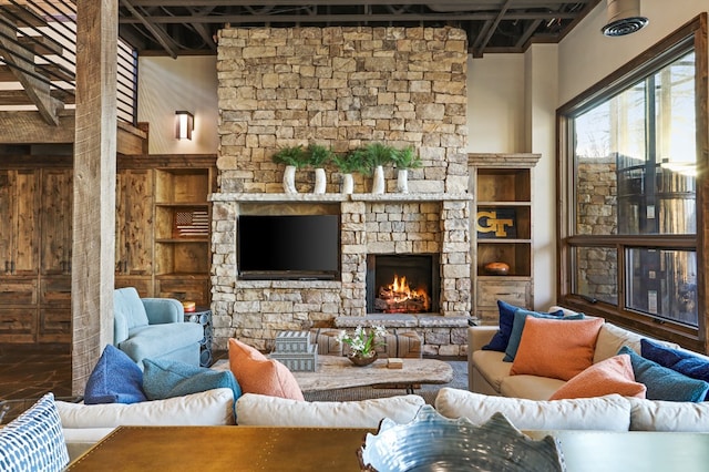 living room featuring a fireplace and a high ceiling