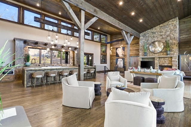 living room featuring a fireplace, wooden ceiling, dark wood-type flooring, and high vaulted ceiling