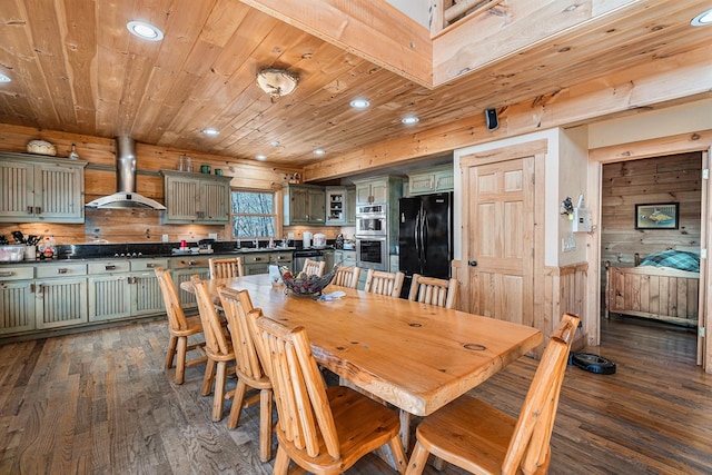 dining room with recessed lighting, wooden walls, wooden ceiling, and dark wood finished floors