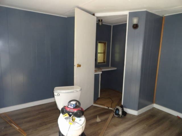 bathroom with toilet and wood-type flooring