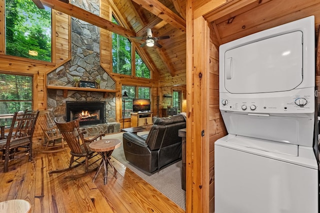 77 Old Covered Bridge Rd, Cherry Log, GA 30522 - laundry area featuring estacked washer and dryer, hardwood / wood-style floors, a stone fireplace, wooden ceiling, and a ceiling fan