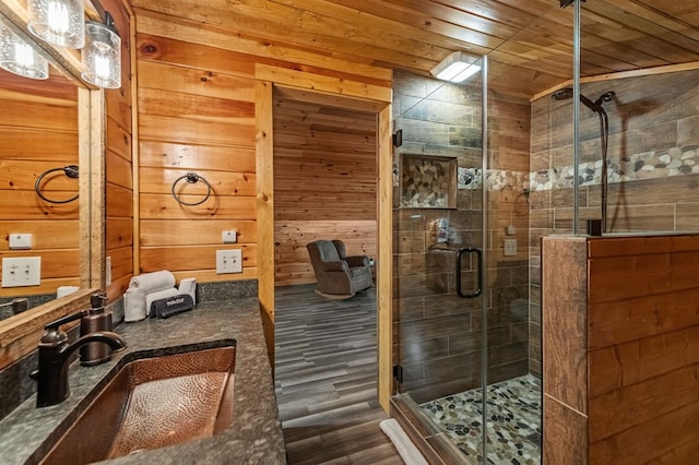 77 Old Covered Bridge Rd, Cherry Log, GA 30522 - full bath featuring wood finished floors, wooden walls, wooden ceiling, a stall shower, and vanity