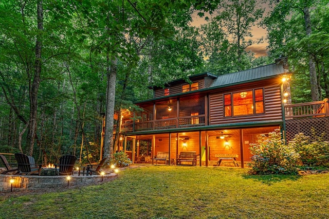 77 Old Covered Bridge Rd, Cherry Log, GA 30522 - rear view of property with an outdoor fire pit, log veneer siding, a lawn, and a metal roof
