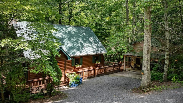 77 Old Covered Bridge Rd, Cherry Log, GA 30522 - view of side of home featuring a metal roof, a wooded view, and a deck
