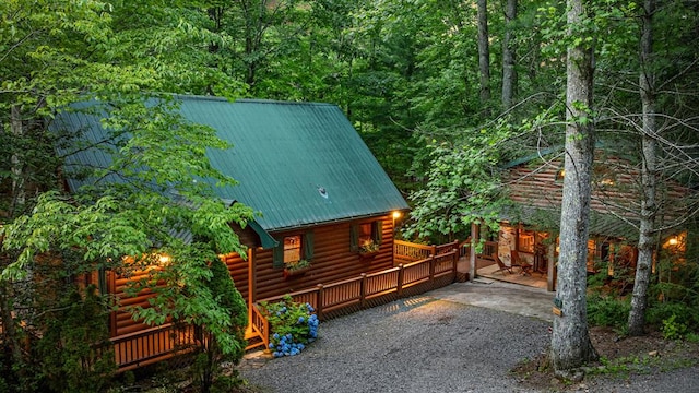 77 Old Covered Bridge Rd, Cherry Log, GA 30522 - view of home's exterior with a metal roof, a forest view, and log veneer siding