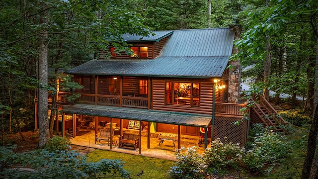 77 Old Covered Bridge Rd, Cherry Log, GA 30522 - rear view of property featuring a metal roof, a patio, a sunroom, and log veneer siding