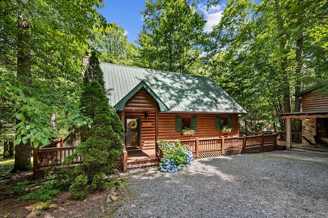 77 Old Covered Bridge Rd, Cherry Log, GA 30522 - view of front of property featuring a chimney, a metal roof, a deck, and faux log siding