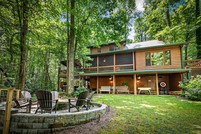 77 Old Covered Bridge Rd, Cherry Log, GA 30522 - rear view of house featuring an outdoor fire pit, log veneer siding, a patio area, a sunroom, and a yard