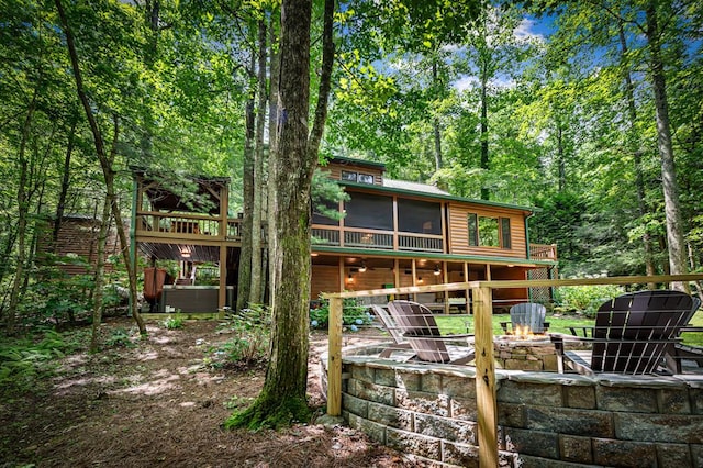 77 Old Covered Bridge Rd, Cherry Log, GA 30522 - back of house featuring faux log siding, a fire pit, a sunroom, and a wooden deck