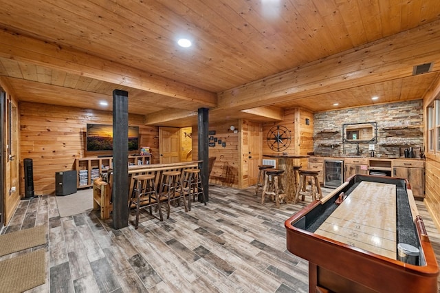 77 Old Covered Bridge Rd, Cherry Log, GA 30522 - rec room with beverage cooler, bar, a wood stove, wood finished floors, and a wooden ceiling with exposed beams