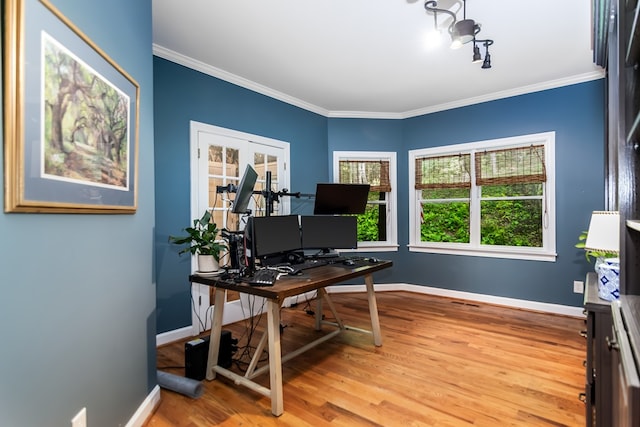 office space featuring baseboards, ornamental molding, and wood finished floors