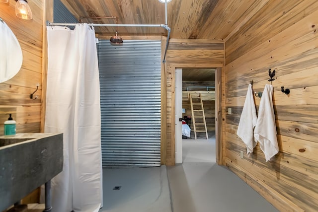 bathroom with wooden ceiling, wooden walls, and finished concrete floors