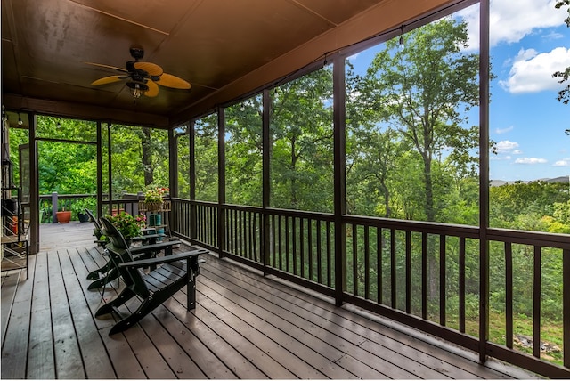 unfurnished sunroom featuring a ceiling fan