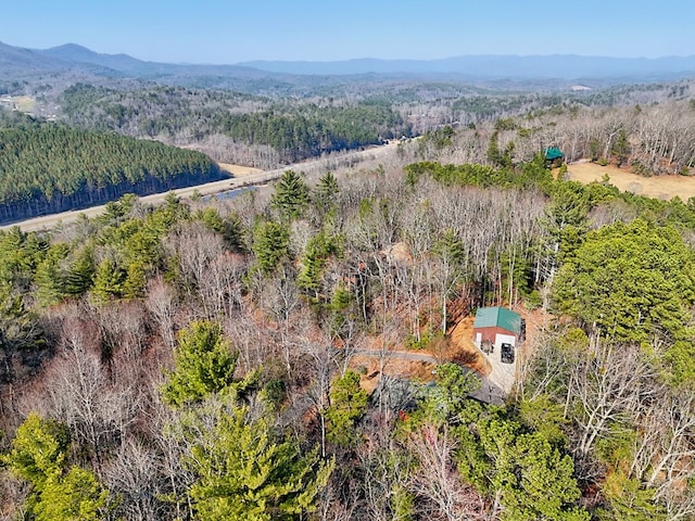 birds eye view of property with a forest view and a mountain view