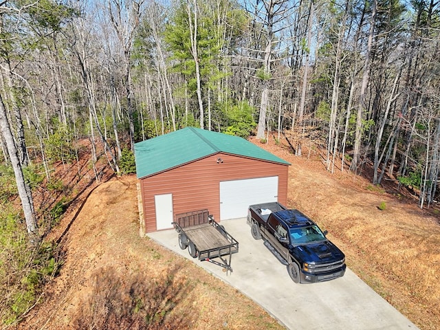 view of outbuilding with a forest view and an outbuilding