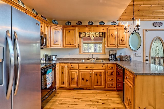 kitchen with light wood-type flooring, a peninsula, brown cabinetry, stainless steel appliances, and a sink