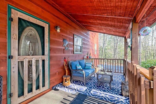 wooden terrace featuring outdoor lounge area