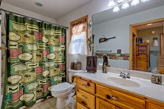 bathroom featuring toilet and vanity